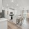 Furnished kitchen with living space in the background